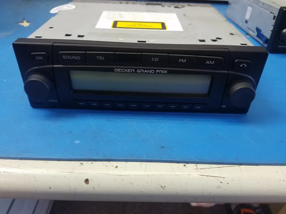 A Becker Grand Prix head unit on the blue workbench upstairs at Becker Auto Sound
