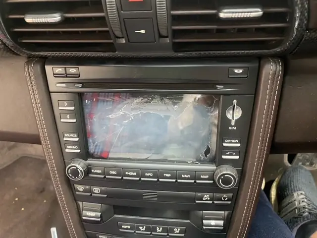A customer's Porsche PCM touch screen, cracked across the display, still in the dash