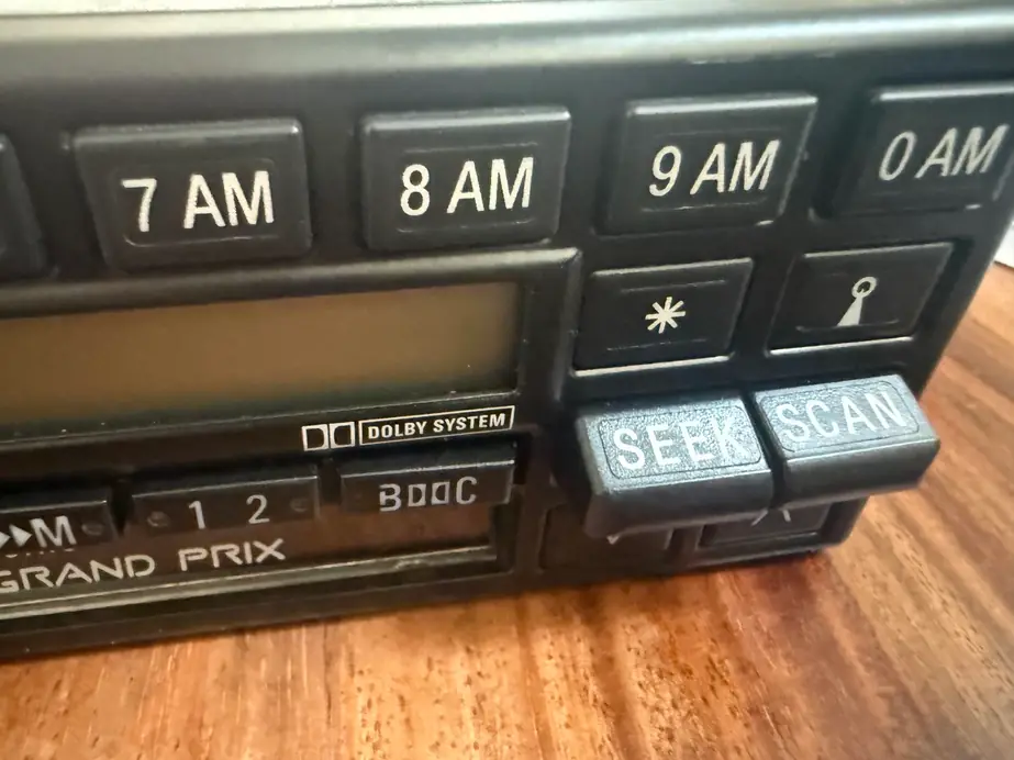 Close-up of a Becker Grand Prix cassette radio with the Dolby System badge and SEEK and SCAN buttons